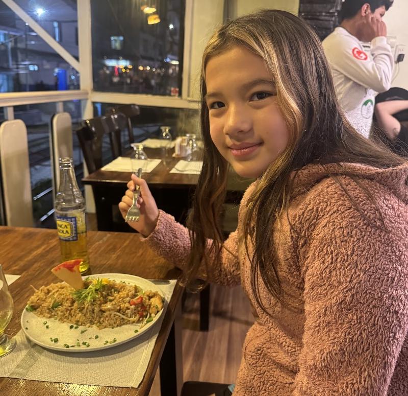 A girl posing with a plate of fried rice