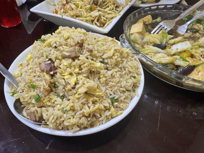 Three dishes of Chinese food at a restaurant